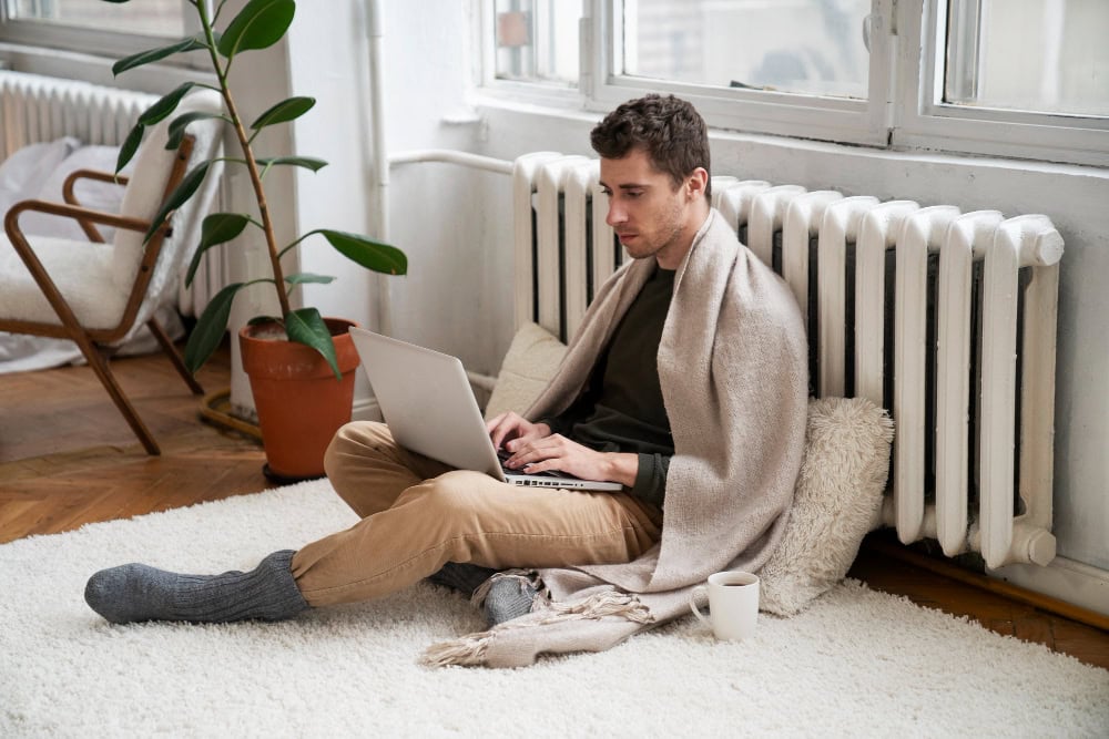 student-in-a-cold-room-sitting-by-the-radiator